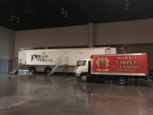 Mark's Carpet Cleaning truck parked inside a large event hall for a commercial job in Omaha, NE