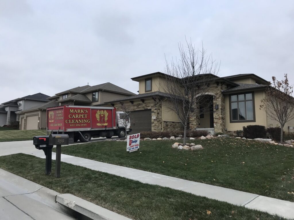Mark's Carpet Cleaning truck parked at a recently sold house for a service in Omaha, NE