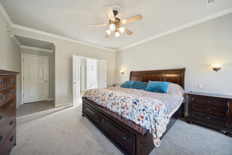 A spacious master bedroom showcasing a new gray carpet installation by B A Carpet and Flooring in Broken Arrow, OK.