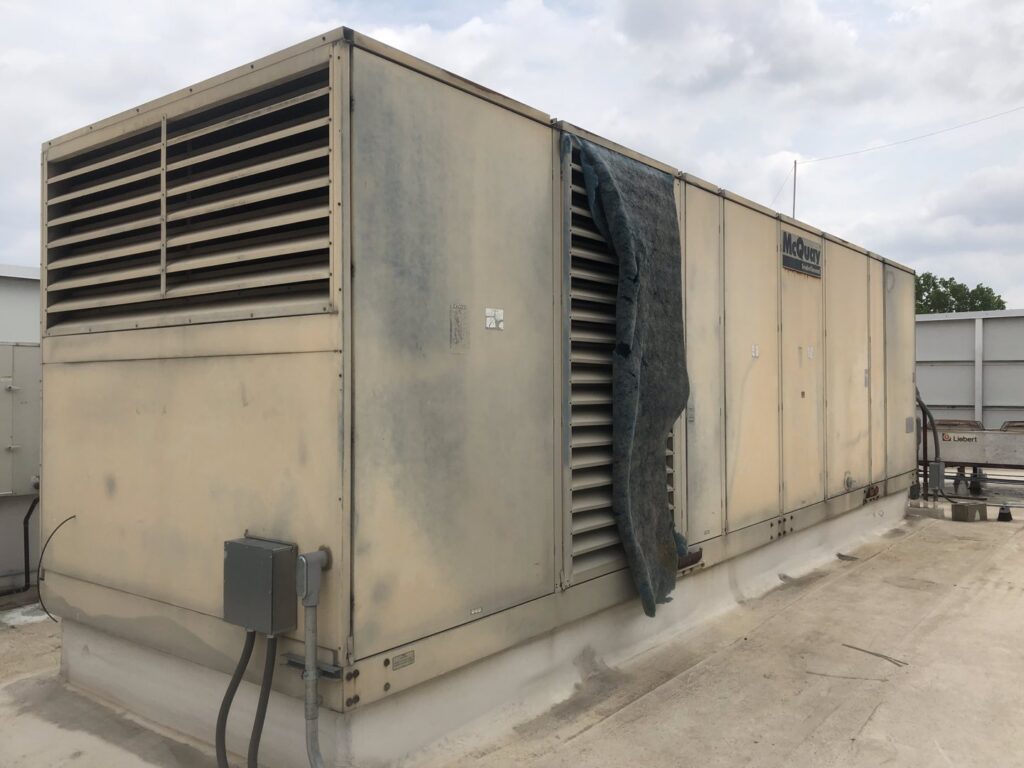 A large McQuay commercial rooftop HVAC unit on a building, maintained by Raleigh Comfort Services in Raleigh, NC.