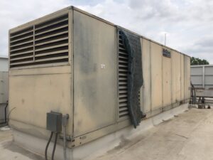 A large McQuay commercial rooftop HVAC unit on a building, maintained by Raleigh Comfort Services in Raleigh, NC.