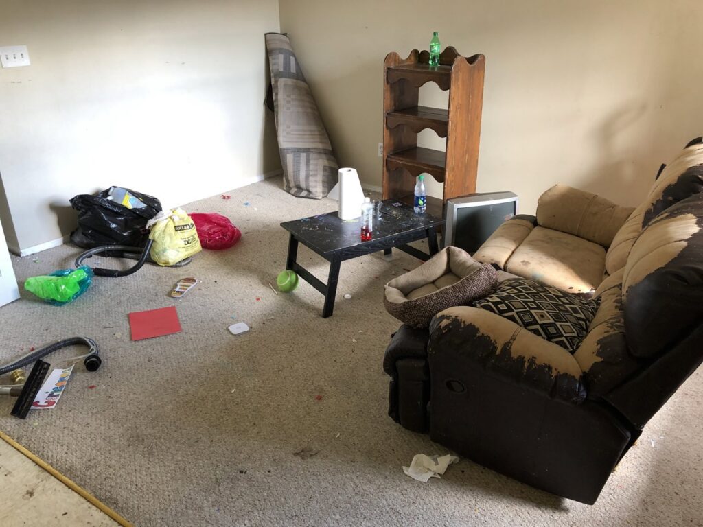 Very messy room with dirty carpet and a rolled-up carpet, awaiting cleanup by Fresh Step Cleaning Services in Owensboro, KY
