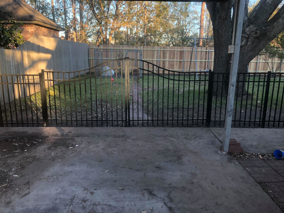 A combination of black metal and wooden privacy fences installed by Paragon Fence, LLC for a home in Colorado Springs, CO.