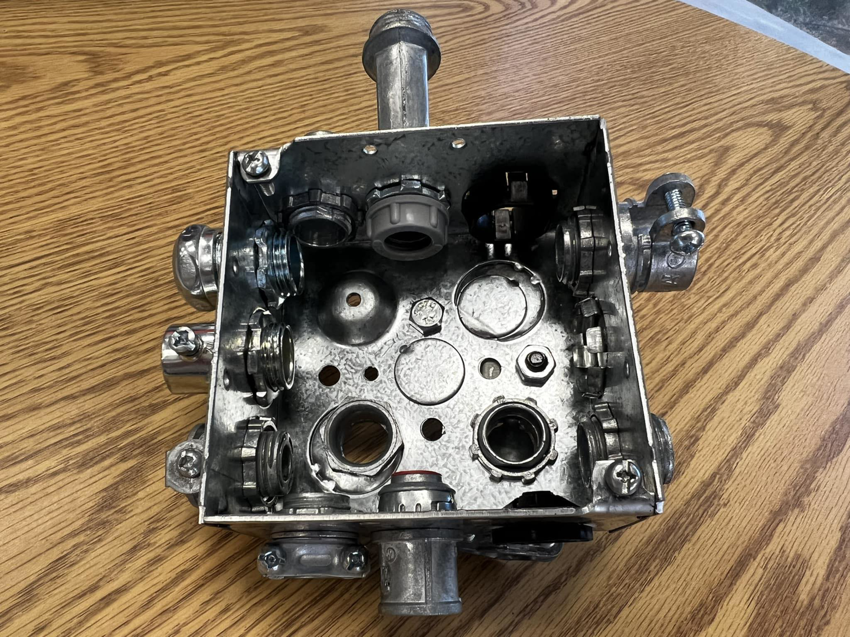 A metal electrical box with various conduit connectors used by The Las Vegas Electrician in Las Vegas, NV