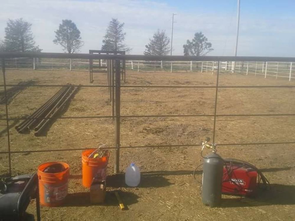Metal fence construction in progress with welding equipment on site by Done Wright Fencing and Welding in Denver, CO.
