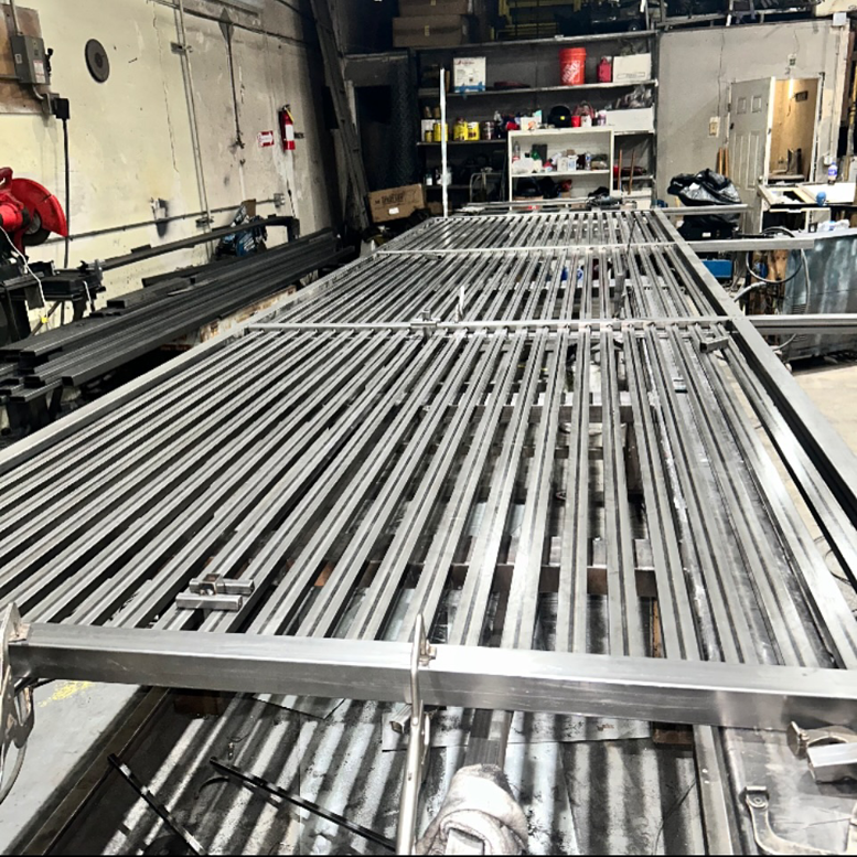 Metal fence or gate sections being fabricated in the workshop by Rossi Welding Metal in Los Angeles, CA.