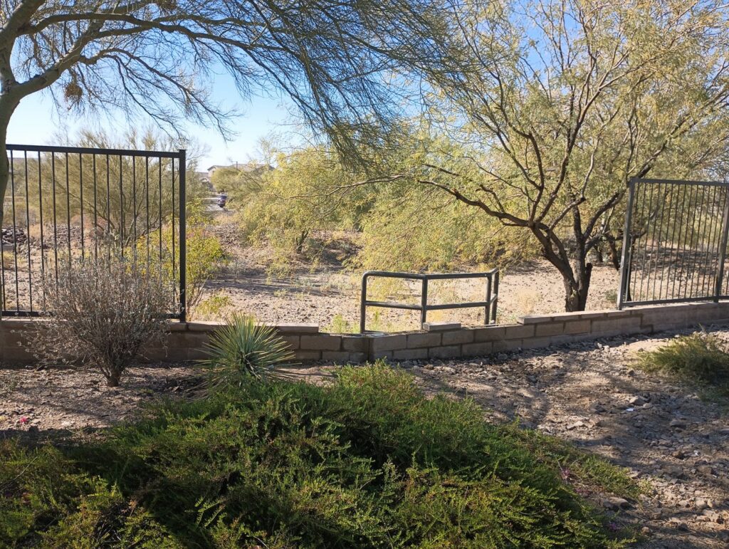 A metal fence combined with a low block wall, installed by Arce Masonry LLC in Glendale, AZ