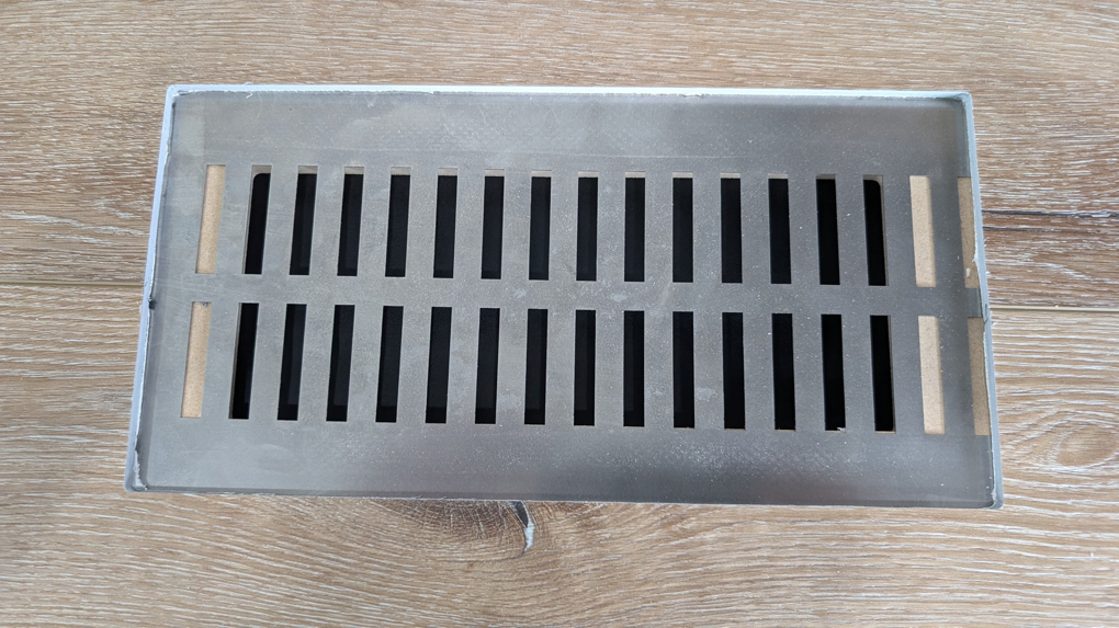 A sleek metal floor vent or register for an HVAC system by BYLT Living in Sandy, UT