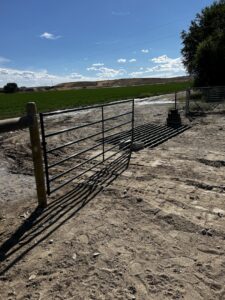 Metal gate and cattle guard installation by Cowboy State Fencing LLC in Riverton, WY.