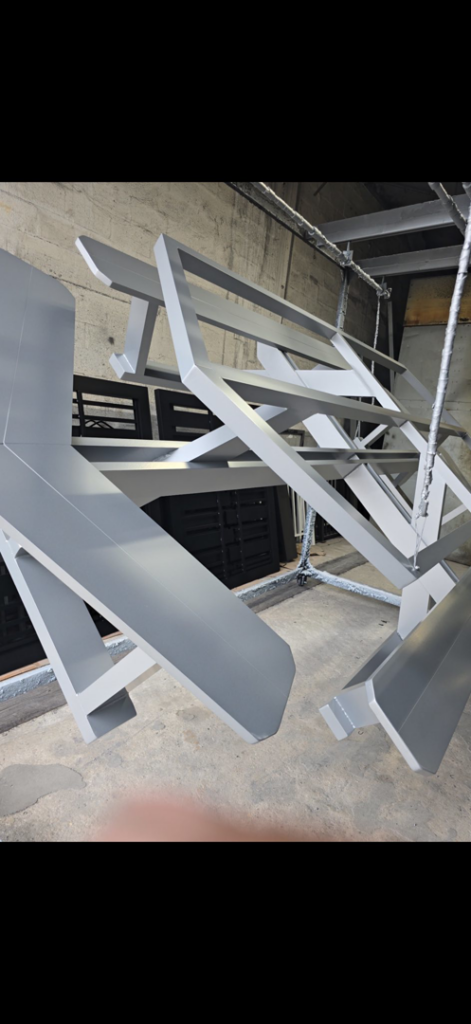 Metal gate and fence components undergoing powder coating at A Master Work Corp. in Hialeah, FL.