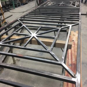 A metal gate frame being fabricated in a workshop by Roy & Son Fencing in Lee's Summit, MO.