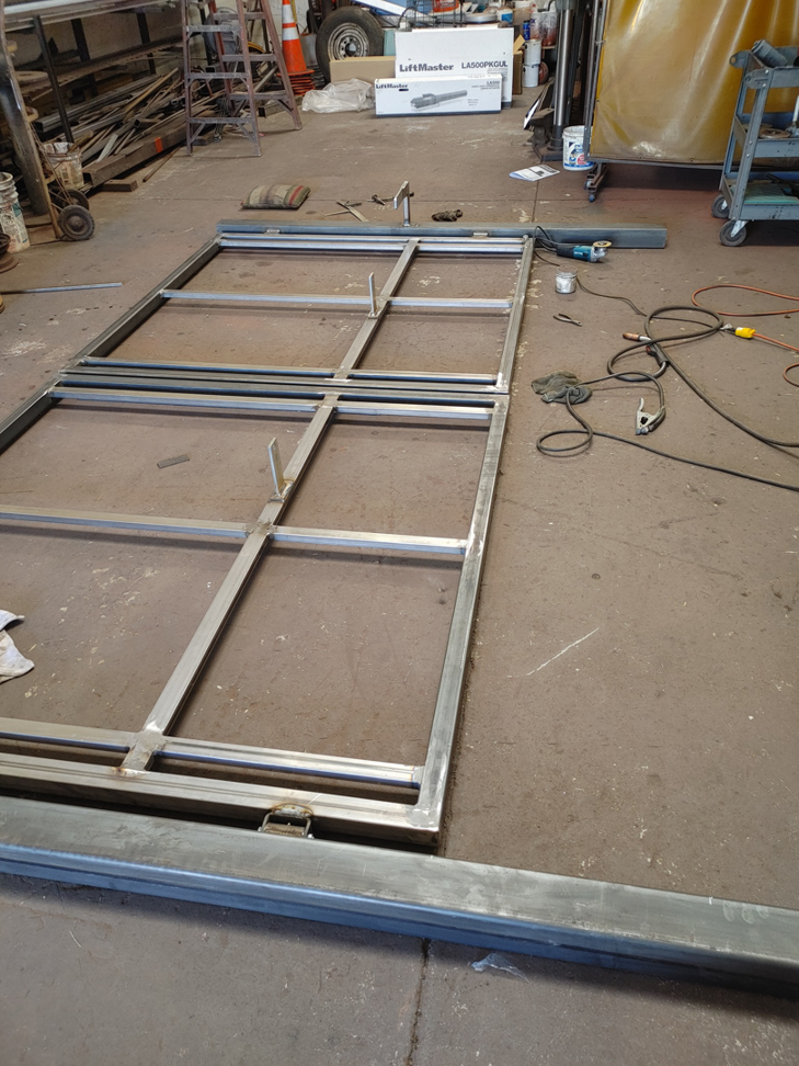 Metal gate frames being fabricated on a workshop floor by Automated Entry Systems Inc in Escondido, CA.