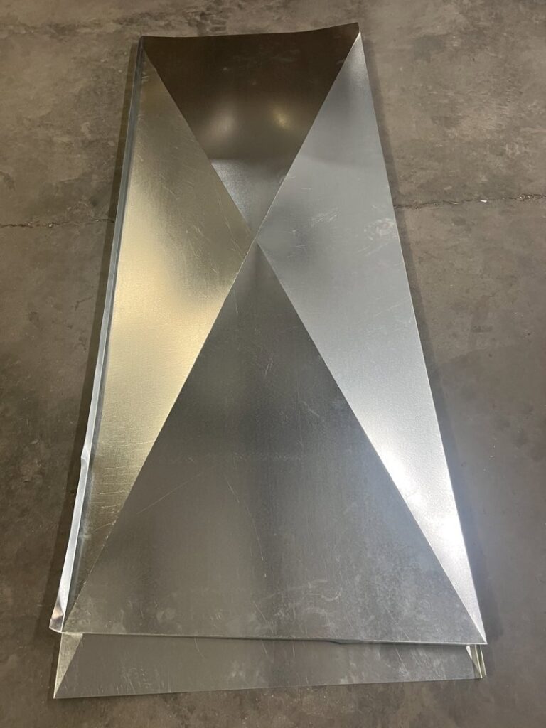 A close-up view of a custom-fabricated metal HVAC duct component from Central Heating & A/C Services, Inc. in Columbia, SC.