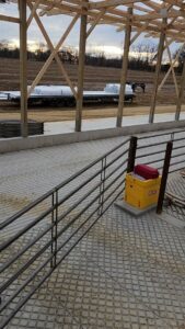 Installed metal livestock railings inside a barn structure by H&S Fencing & Supply in Linden, WI.