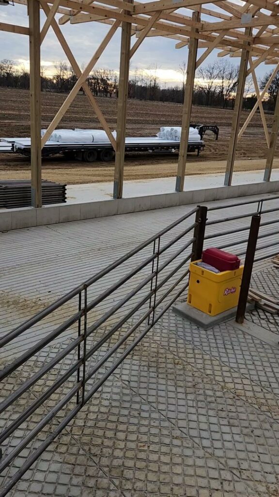Installed metal livestock railings inside a barn structure by H&S Fencing & Supply in Linden, WI.