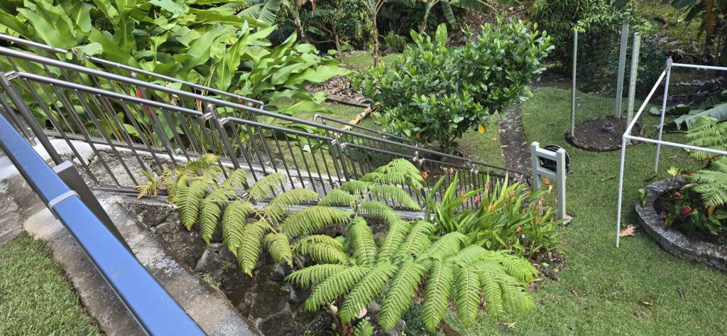 A durable metal railing installed along outdoor stairs by KunkelWorks Hawaii in Mililani, HI.
