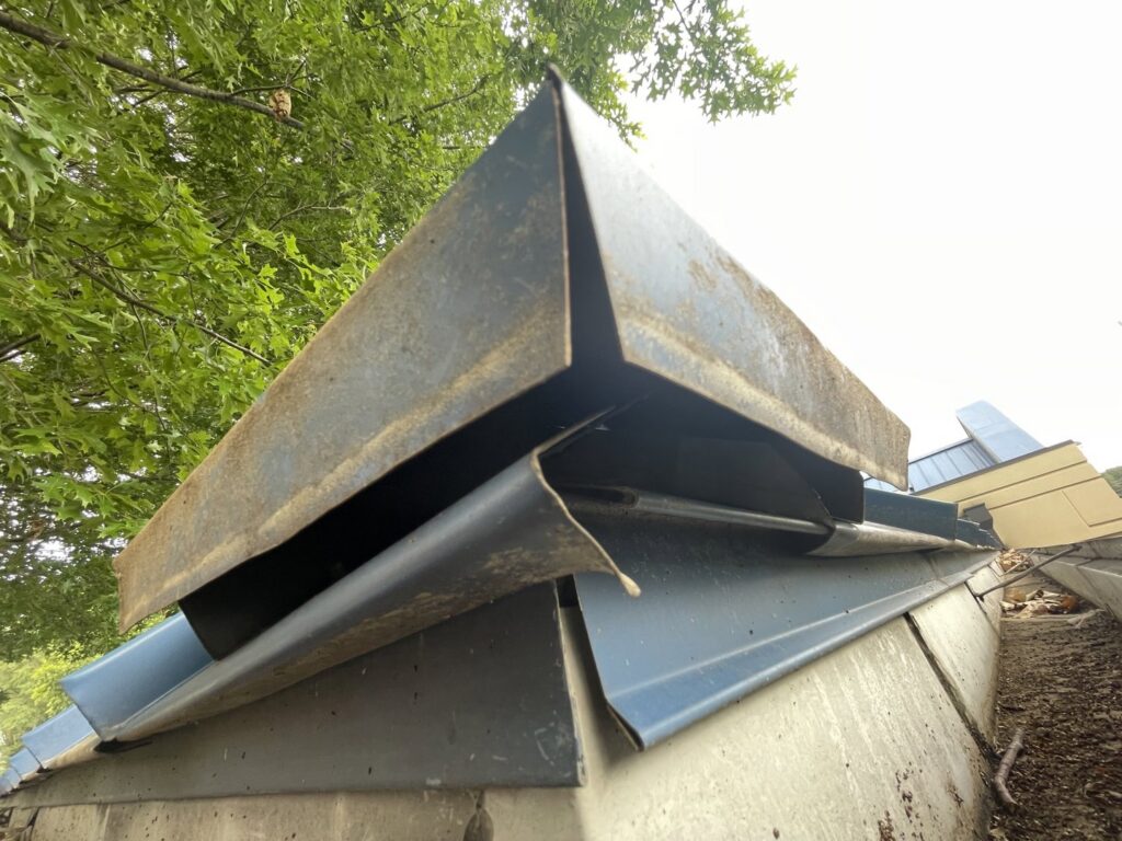 A metal roof vent showing signs of damage or needing exclusion repair by The Squirrel Guys in Birmingham, AL.