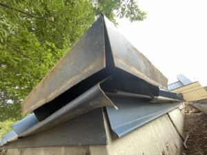 A metal roof vent showing signs of damage or needing exclusion repair by The Squirrel Guys in Birmingham, AL.