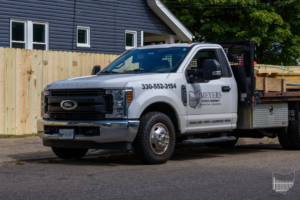 Meyers Fence Company truck with materials parked in front of a newly installed wood privacy fence in Kent, OH