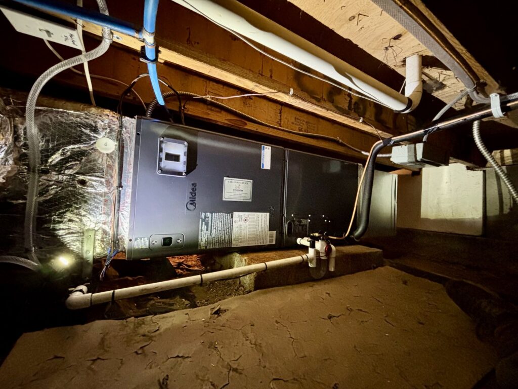 A Midea air handler unit installed in a crawl space by Kingdom Heating and Air in Sacramento, CA.