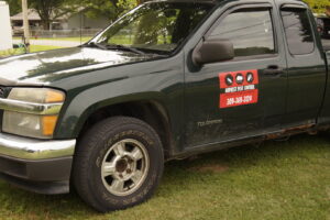 A green service truck with the Midwest Pest Control logo and contact information, serving clients in East Peoria, IL.
