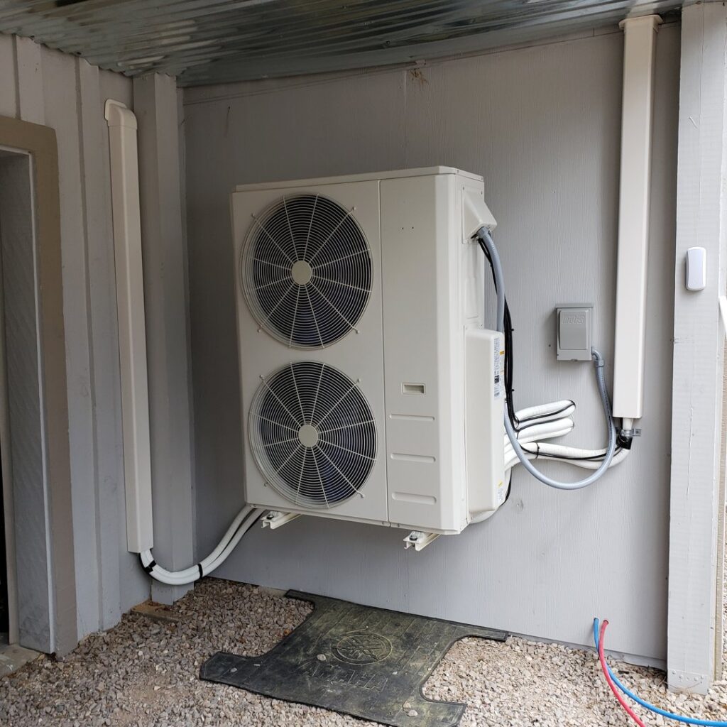 An outdoor mini-split air conditioning condenser unit installed by Reading Plumbing, Heating & Air Conditioning in Roswell, NM