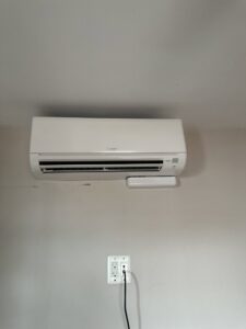 A wall-mounted mini-split AC unit with a dedicated electrical outlet installed by GEN3 Electric & HVAC in Philadelphia, PA.
