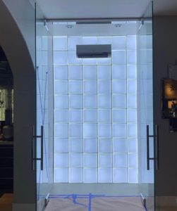 A newly installed mini-split air conditioning unit above a glass block wall by ProMasters HVAC Mechanical in New York, NY