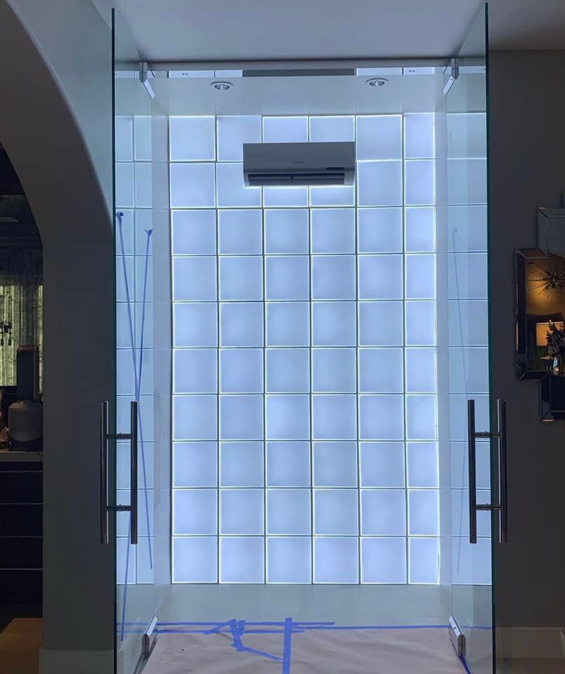 A newly installed mini-split air conditioning unit above a glass block wall by ProMasters HVAC Mechanical in New York, NY