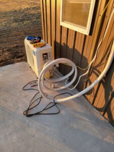 A mini-split air conditioning unit being installed by Working Wolves Heating & Cooling LLC in Lawrence, KS.