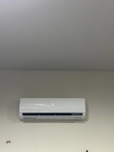 A close-up of an indoor mini-split air conditioning unit displaying the temperature 72, serviced by Golden Heating and Air LLC in Arvada, CO.