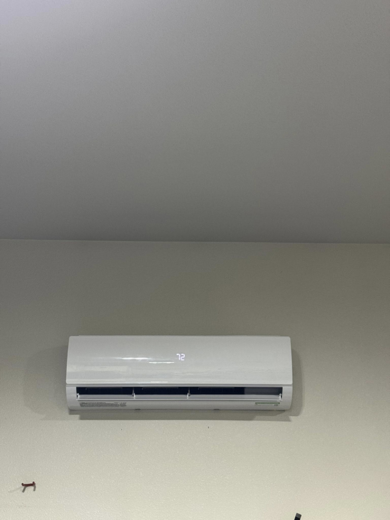 A close-up of an indoor mini-split air conditioning unit displaying the temperature 72, serviced by Golden Heating and Air LLC in Arvada, CO.