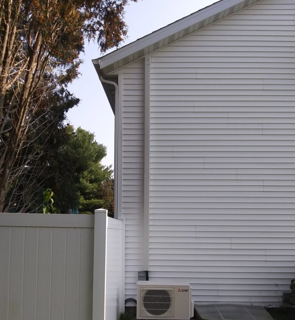 A newly installed outdoor mini-split air conditioning unit on the side of a house by Your HVAC Guy in Aurora, IL.