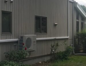 A mini-split air conditioning unit installed on the side of a house by Accurate Conditioning in Sayreville, NJ.
