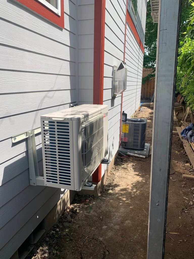 An outdoor mini-split system and a traditional AC unit installed by Excellence Heating & Cooling, LLC. in Beaverton, OR.