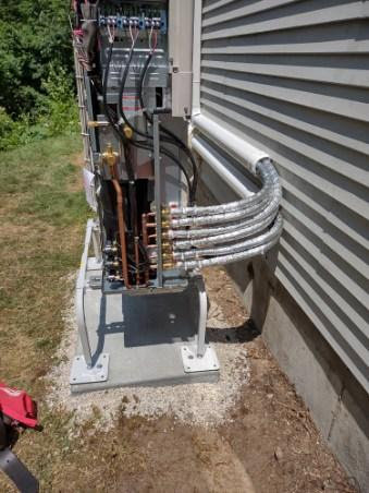Close-up of the internal components and piping of a mini-split condenser by Hampden County HVAC Inc. in Indian Orchard, MA