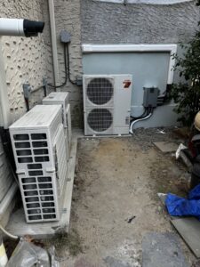 Two outdoor mini-split air conditioning condenser units installed next to a building by L&SON Heat AC Tech in Yonkers, NY.