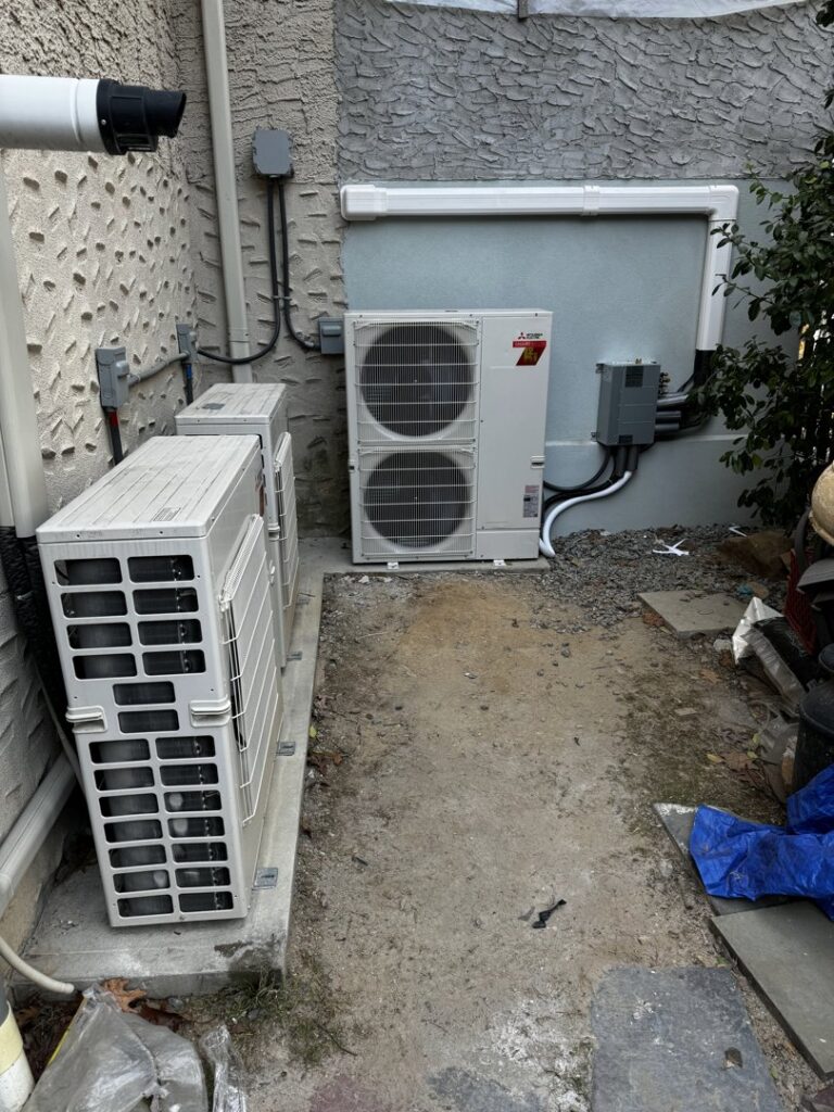 Two outdoor mini-split air conditioning condenser units installed next to a building by L&SON Heat AC Tech in Yonkers, NY.