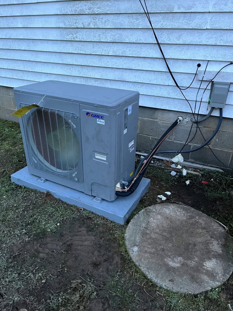 A new outdoor mini-split or heat pump unit installed on a concrete pad by Climate Mechanical in Dinwiddie, VA.