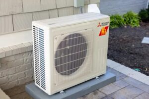 An outdoor Mitsubishi Electric mini-split heat pump unit installed by Crome Mechanical Inc. in Cedar Springs, MI