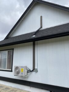 A newly installed outdoor mini-split heat pump unit on the side of a home by Desert Air, LLC in Sun Valley, NV.