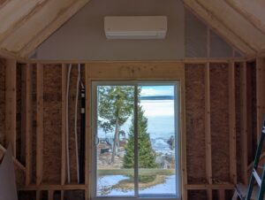 An indoor mini-split heat pump head unit installed in a room under construction by Kinney Family Heat Pumps in Augusta, ME.