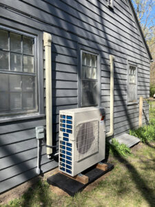 An outdoor mini-split HVAC unit professionally installed by Cloud Heating & Air Conditioning in Lawrence, KS.