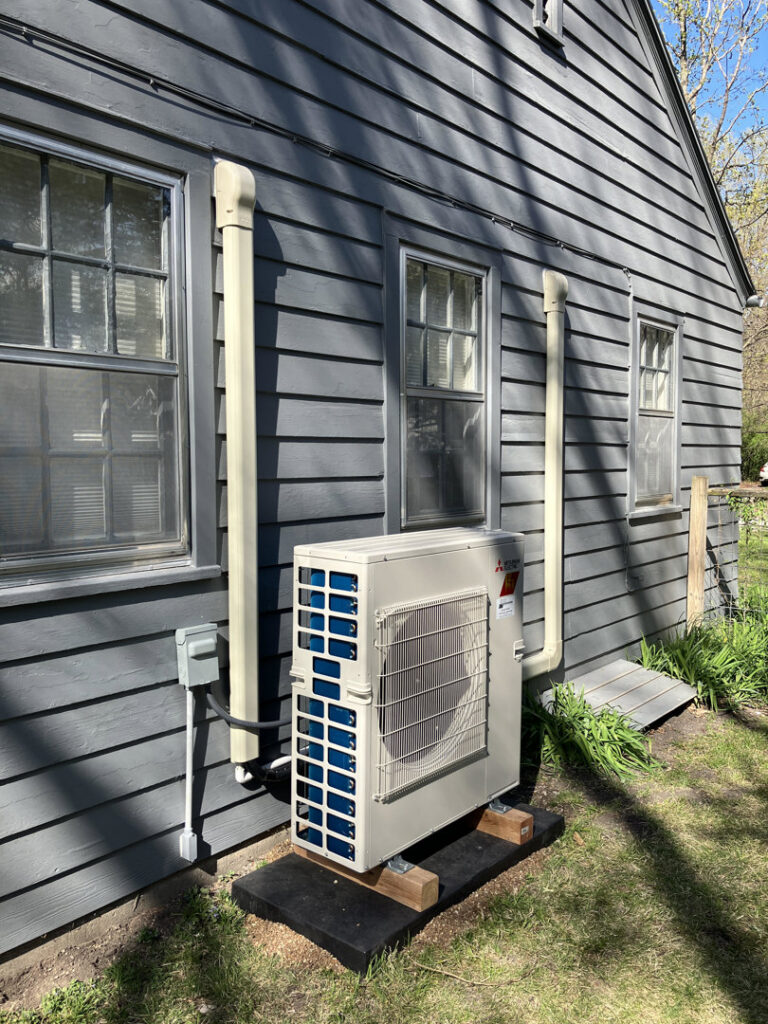 An outdoor mini-split HVAC unit professionally installed by Cloud Heating & Air Conditioning in Lawrence, KS.