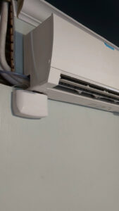 Side view of a mini-split HVAC unit showing refrigerant lines and electrical connections by Gahanna Heating & Cooling, Columbus, OH.