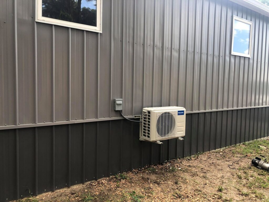 Mini-split HVAC unit installed on the exterior of a metal building by Huggins Mechanical in Jacksonville, FL