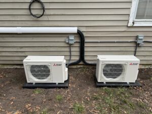 Two Mitsubishi Electric mini-split HVAC units installed outside a building by Krantz Kooling & Heating in West Columbia, SC