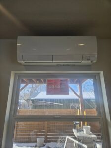 A mini-split indoor unit installed above a window by 406 Heating & Cooling LLC in Missoula, MT.