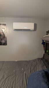 An indoor mini-split head unit installed on a bedroom wall by Climate Diagnostics in Buffalo, NY.