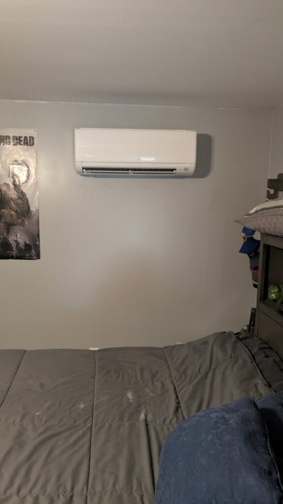 An indoor mini-split head unit installed on a bedroom wall by Climate Diagnostics in Buffalo, NY.